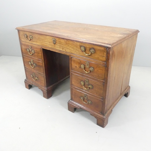 2640 - A Georgian oak center standing kneehole writing desk, with well-fitted top drawer and six drawers un... 