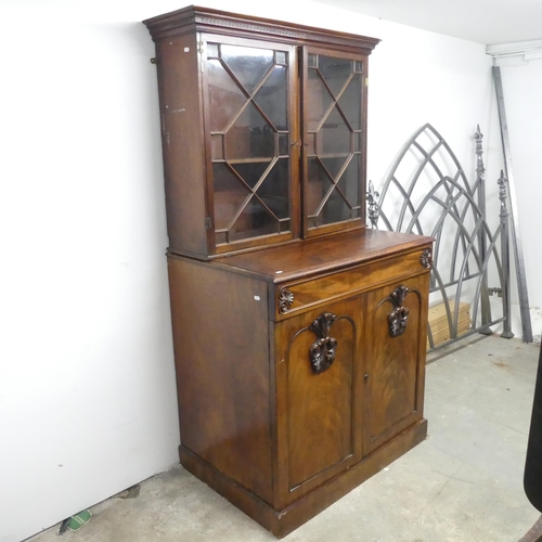 2643 - An antique mahogany two-section bookcase on cabinet, the base having a single frieze drawer and slid... 