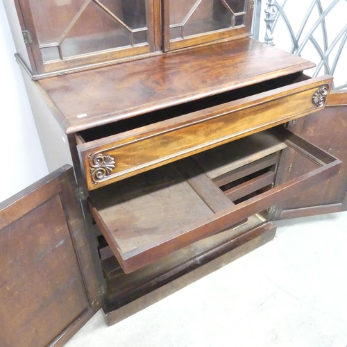 2643 - An antique mahogany two-section bookcase on cabinet, the base having a single frieze drawer and slid... 