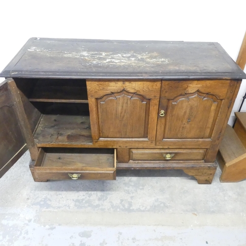 2645 - An antique panelled oak mule chest, with two cupboard doors and drawers under, and raised on bracket... 