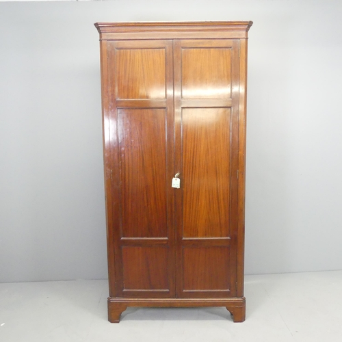 2669 - An antique mahogany corner cupboard, with two panelled doors and four shelves. 92x184x48cm.