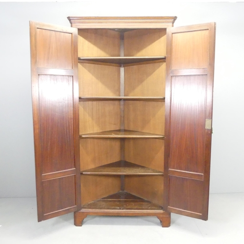 2669 - An antique mahogany corner cupboard, with two panelled doors and four shelves. 92x184x48cm.