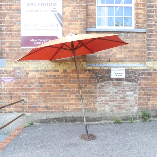 2696 - A Garden parasol on cast iron base. Diameter approximately 275cm, height 235cm.