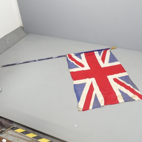 2703 - A vintage sewn Union Flag on pole. 135x96cm, pole length 230cm.