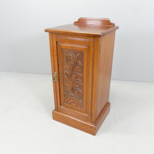 2709 - An Art Nouveau style mahogany pot cupboard with carved and panelled door. 40x81x36cm.