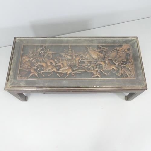 2714 - A Chinese opium table with glass top over carved decoration.   102x42x46cm.