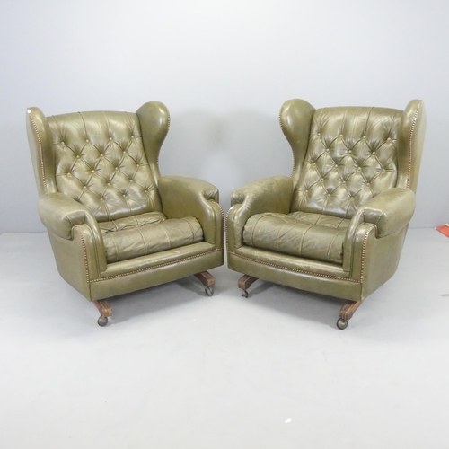 2717 - A pair of Green button-back leather upholstered reclining wing armchairs, with studded decoration. O... 