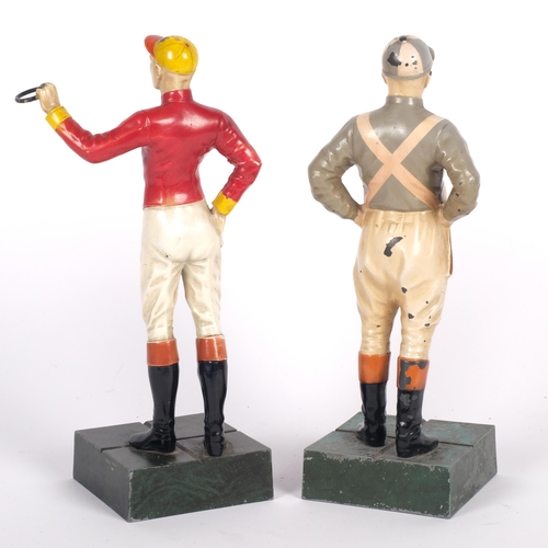 517 - 2 cold painted cast-metal figures, study of jockeys, on plinth bases, overall height 26cm
