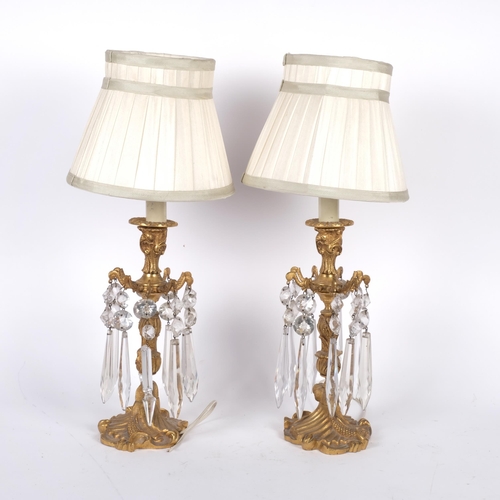 539 - A pair of gilt brass table lamp, with glass lustres and pleated shades, overall height 47cm