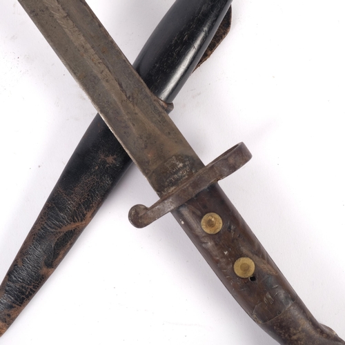 557 - A First World War Period bayonet, with impressed marks, L42cm, and a small ebony barrel handled knif... 