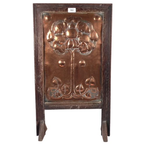 562 - A Victorian Art Nouveau fire screen, with stylised repousse copper panel, oak-framed, H69cm