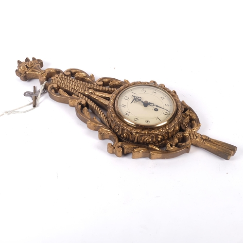 583 - An Atsonea 20th century giltwood cartelle style clock, with Smiths 8-day movement, L55cm