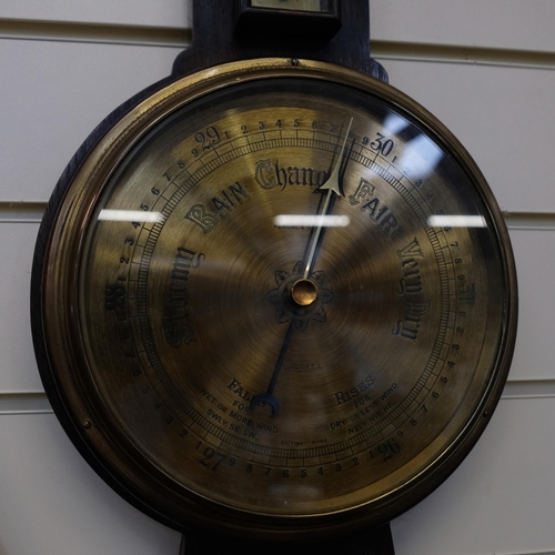 619 - An Art Nouveau oak-framed aneroid barometer with thermometer, by Kendal & Dent, L77cm