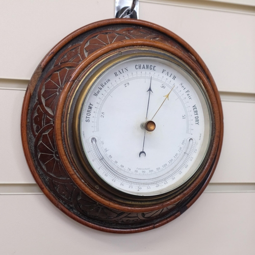 620 - An Edwardian carved oak-cased combination aneroid barometer with thermometer, diameter 20cm