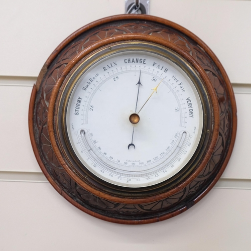 620 - An Edwardian carved oak-cased combination aneroid barometer with thermometer, diameter 20cm