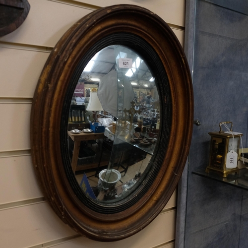 621 - 19th century giltwood oval framed wall mirror, H52cm