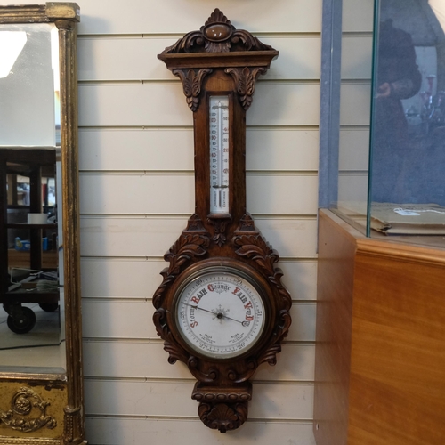 622 - A lovely carved oak aneroid barometer, with mercury thermometer, length 95cm