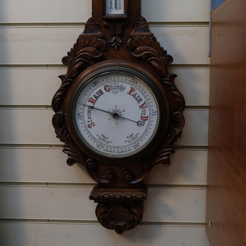 622 - A lovely carved oak aneroid barometer, with mercury thermometer, length 95cm