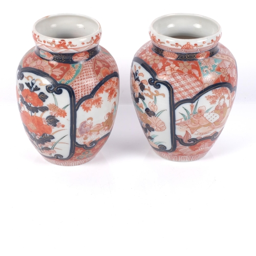 627 - A pair of Japanese Kutani baluster vases, with painted decoration, H15cm