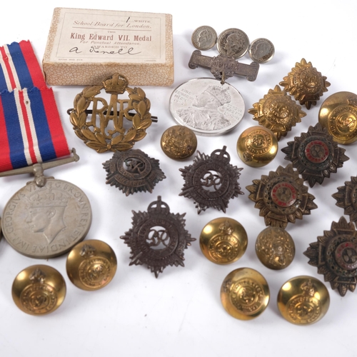 651 - A group of 3 World War II medals, various military badges and buttons, and a King Edward VII medal n... 