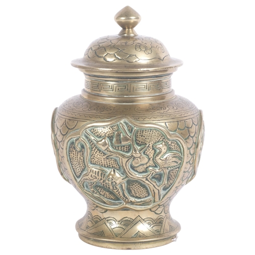 720 - A brass Chinese preserve pot with lid, with high relief decoration in various animals, including var... 