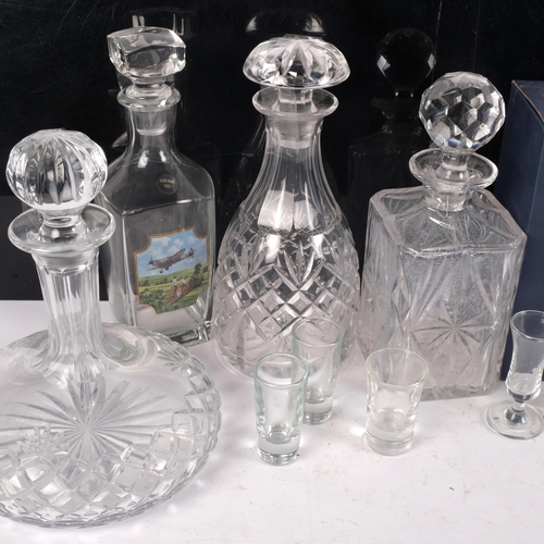 899 - A group of decanters and stoppers, including a ship's decanter, 24cm, vase and glasses