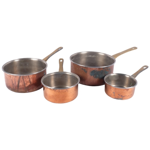 910 - A graduated set of 4 copper saucepans with brass handles, largest diameter 20cm