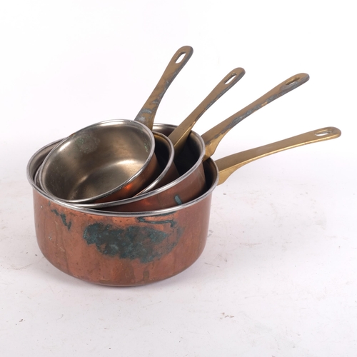 910 - A graduated set of 4 copper saucepans with brass handles, largest diameter 20cm