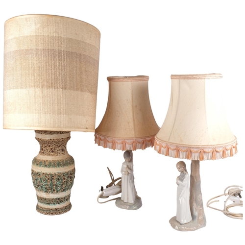 916 - A pair of Spanish figure table lamps and shades, and an embossed pottery table lamp with shade