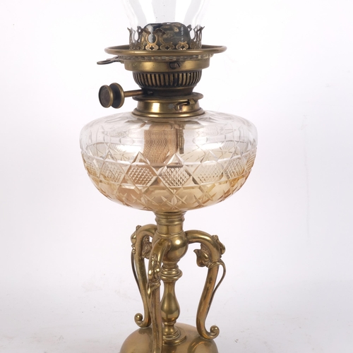 917 - An Art Nouveau brass oil lamp with foliate decorated base, cut-glass font, with chimney, H60cm