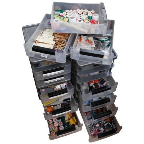 1162 - 2 stacks of plastic containers, containing sewing equipment, cotton reels, patterns, and related ite... 