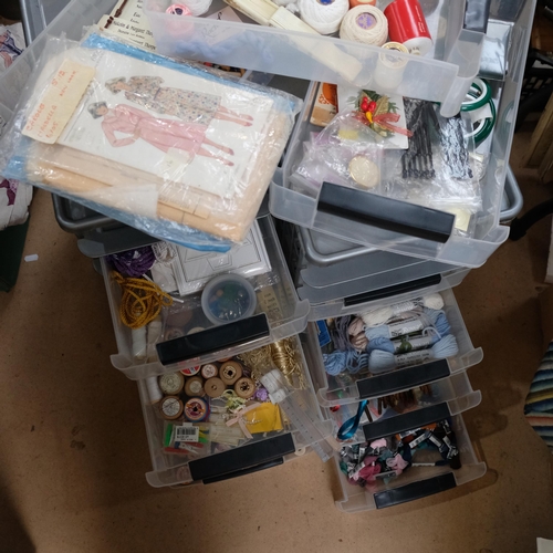 1162 - 2 stacks of plastic containers, containing sewing equipment, cotton reels, patterns, and related ite... 