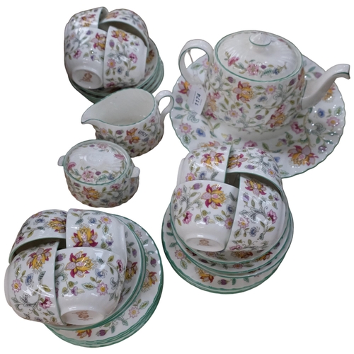 1174 - A Minton Haddon Hall tea service, comprising teapot, large plate, 12 cups, 12 saucers, 8 tea plates,... 