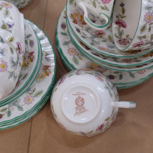 1174 - A Minton Haddon Hall tea service, comprising teapot, large plate, 12 cups, 12 saucers, 8 tea plates,... 