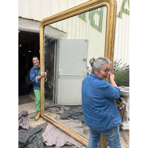 386 - An extremely large Louis Phillipe mirror, with gilt gesso cushion and beaded frame, 230 x180cm