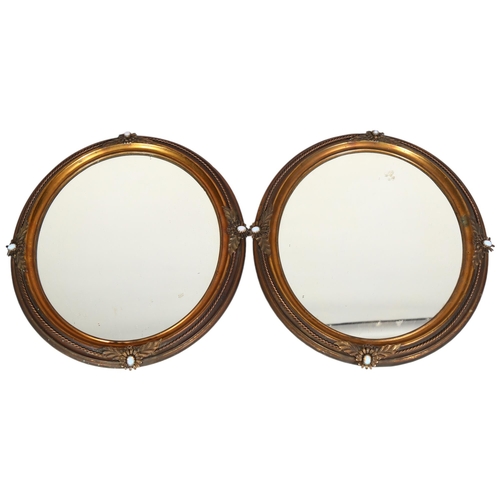 134 - A pair of Victorian oval gilt-brass framed wall mirrors, with rope twist surrounds and inset opaline... 