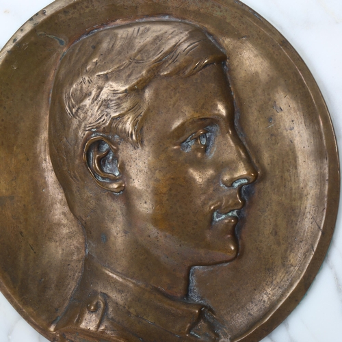 135 - A bronze relief plaque depicting Wilfred Owen (1893 - 1918), set into white marble background in mod... 