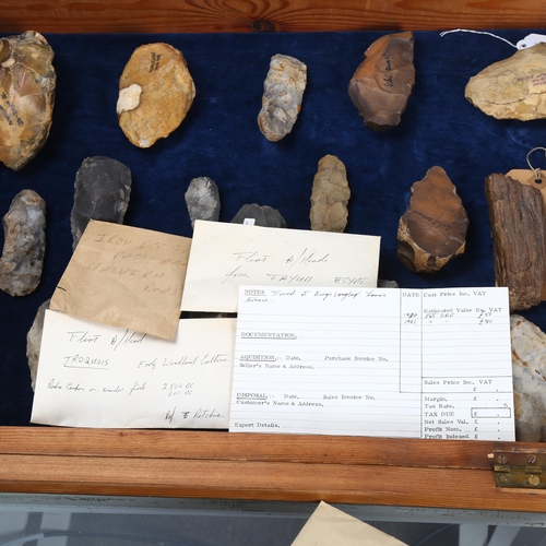 139 - A museum display of flint hand axes, spearheads, petrified wood specimen etc, in glazed pine display... 