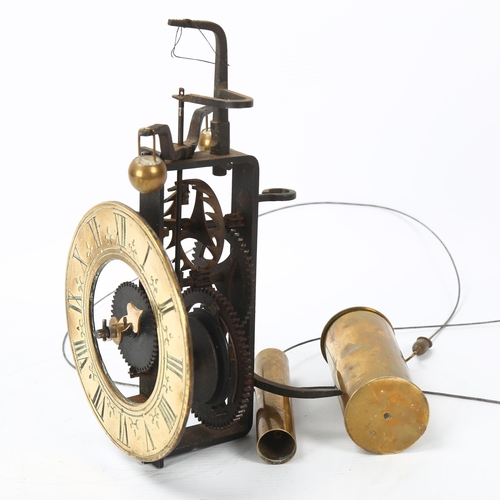 150 - A wall-hanging gravity clock, engraved brass chapter ring with iron movement, together with weights,... 