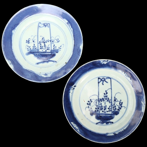 221 - A pair of Chinese Kangxi blue and white porcelain plates with painted baskets of flowers, diameter 1... 