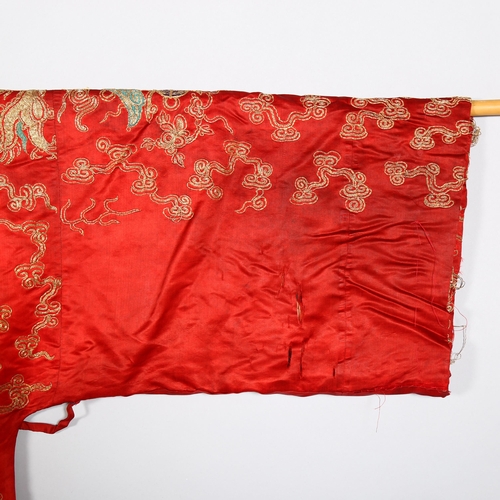 237 - A Chinese red silk jacket with colourful embroidered and gold braid dragons probably early 20th cent... 