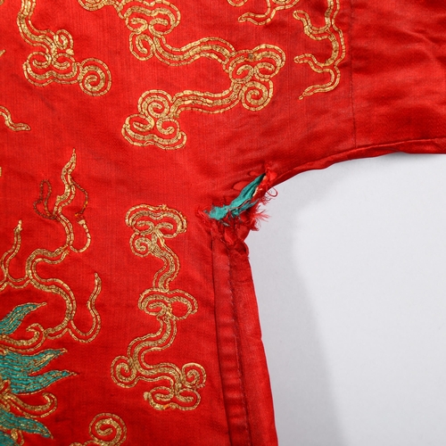 237 - A Chinese red silk jacket with colourful embroidered and gold braid dragons probably early 20th cent... 