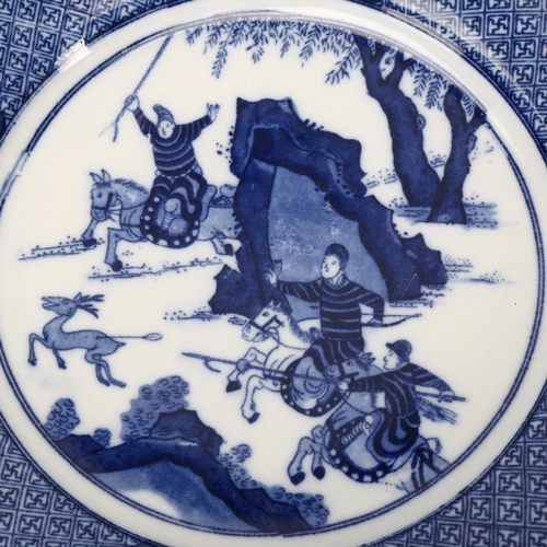 238 - A Chinese blue and white porcelain plate with hunting scene, 6 character mark, diameter 23cm