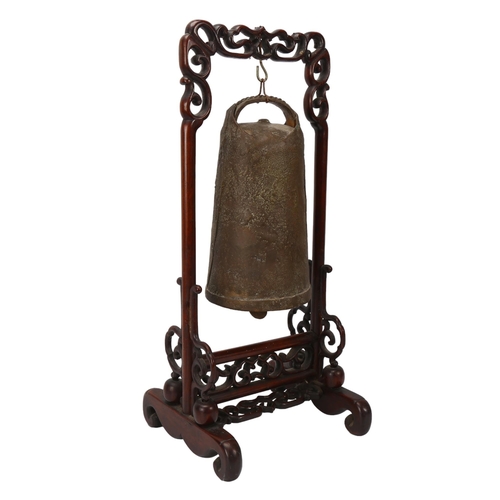 245 - A Chinese bronze bell on carved and pierced hardwood stand, height 46cm