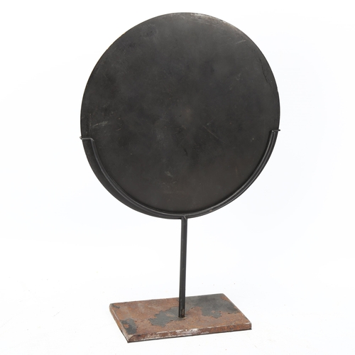 256 - A Chinese relief cast bronze mirror, diameter 19cm, on modern metal stand