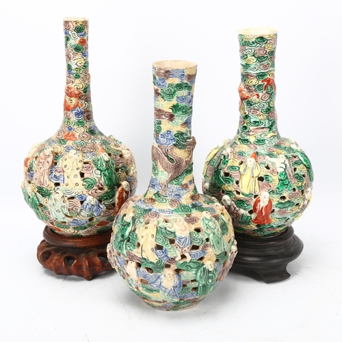 259 - 3 Chinese porcelain bottle vases, late 19th/early 20th century, with relief moulded figures and pier... 