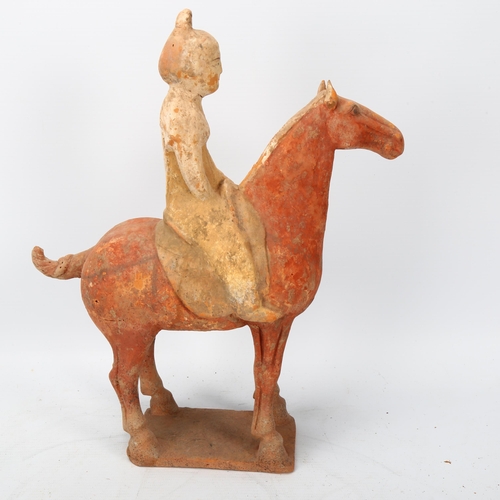 268 - A Chinese Tang style terracotta horse and rider, height 31cm