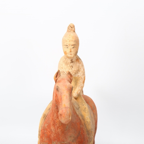 268 - A Chinese Tang style terracotta horse and rider, height 31cm