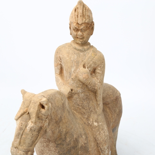 269 - A Chinese Tang style terracotta horse and rider, height 31cm