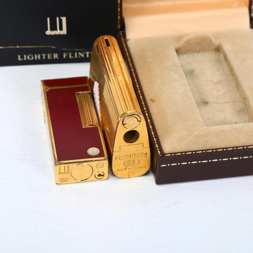 283 - Dunhill red enamel pocket lighter, boxed, and a Ronson gold plated pocket lighter (2)